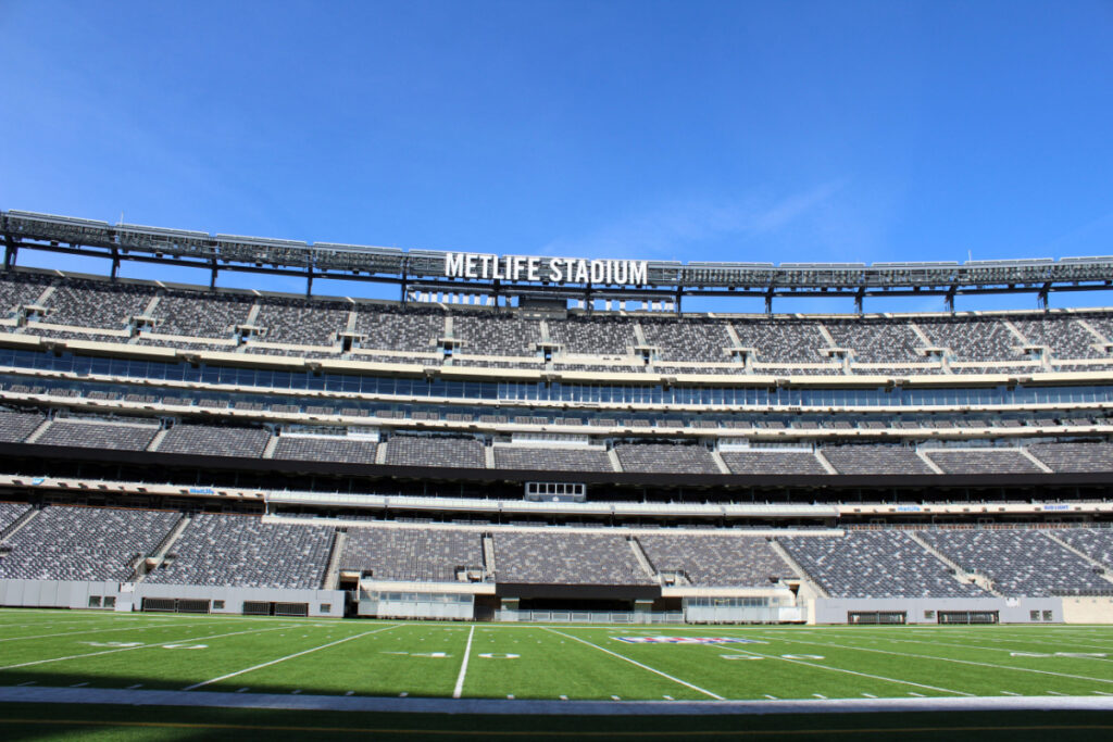 Empty football field at MetLife stadium on a sunny day.