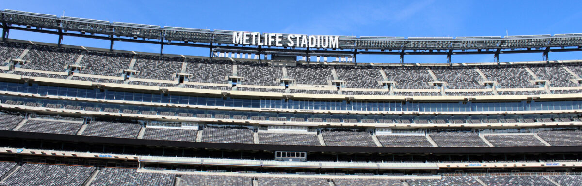 Empty football field at MetLife stadium on a sunny day.