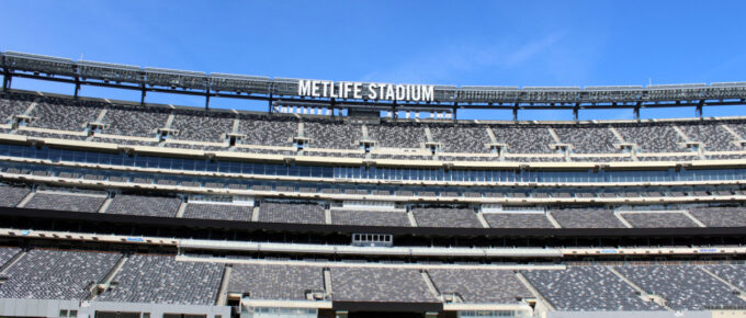 Empty football field at MetLife stadium on a sunny day.