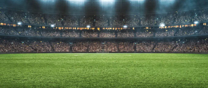 A soccer stadium full of lights at night.