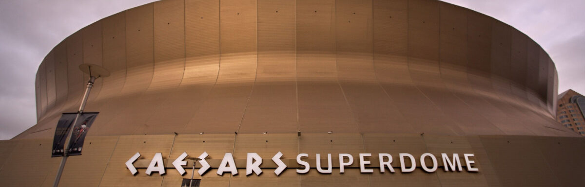 In front of Caesars Superdome at night.