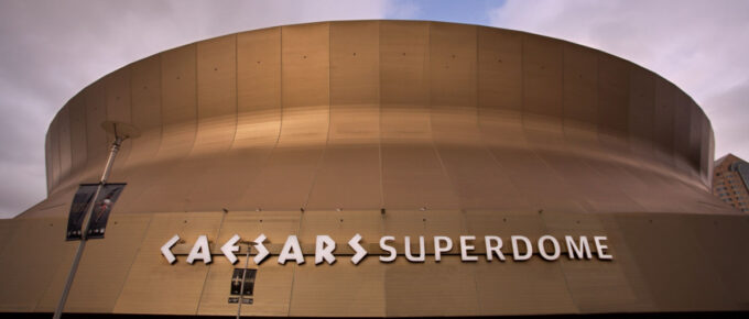 In front of Caesars Superdome at night.