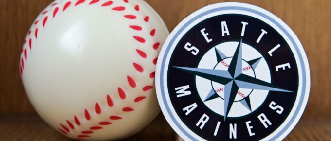 The emblem of the baseball club Seattle Mariners and a baseball.