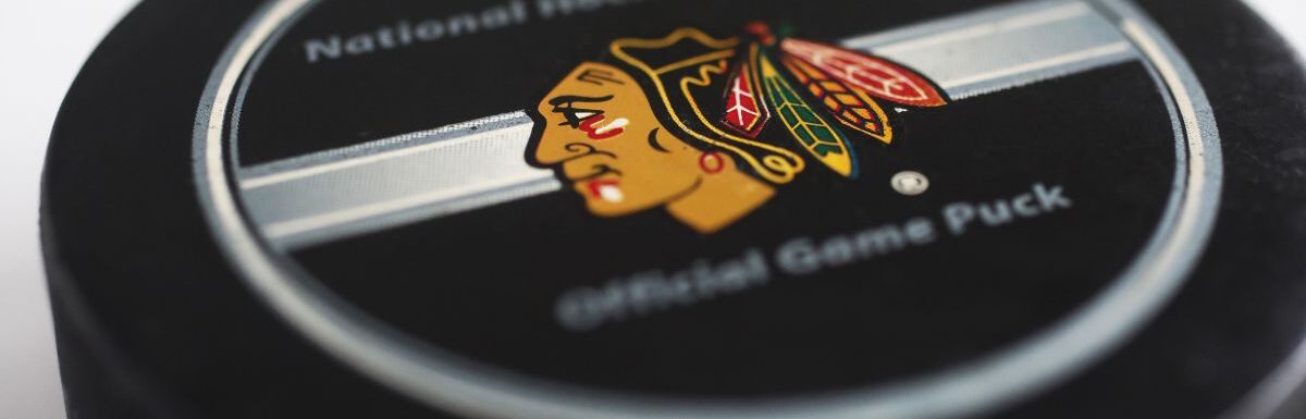 A hockey puck with emblems of Chicago Blackhawks and with the text National hockey league.