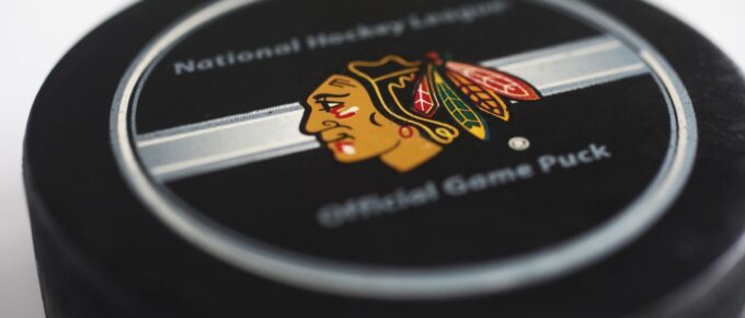 A hockey puck with emblems of Chicago Blackhawks and with the text National hockey league.
