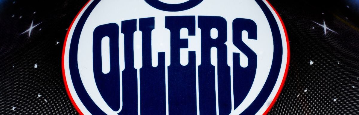The NHL team Edmonton oilers logo printed on goalie helmet.