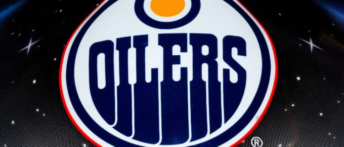 The NHL team Edmonton oilers logo printed on goalie helmet.