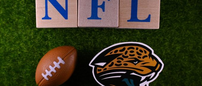 The emblem of the Jacksonville Jaguars football club on the green lawn of the stadium.