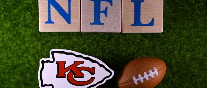 The emblem of the Kansas City Chiefs football club on the green lawn of the stadium.