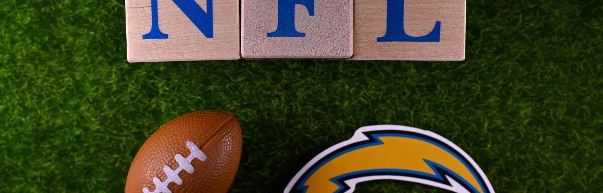 The logo of the Los Angeles Chargers football club on the green lawn of the stadium.