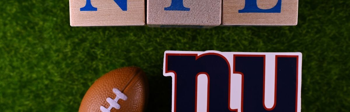 The emblem of the New York Giants football club on the green lawn of the stadium.