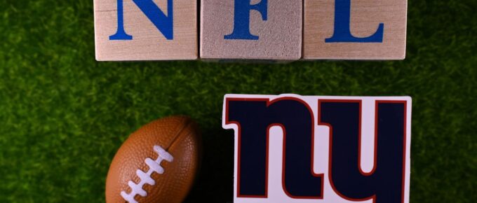 The emblem of the New York Giants football club on the green lawn of the stadium.