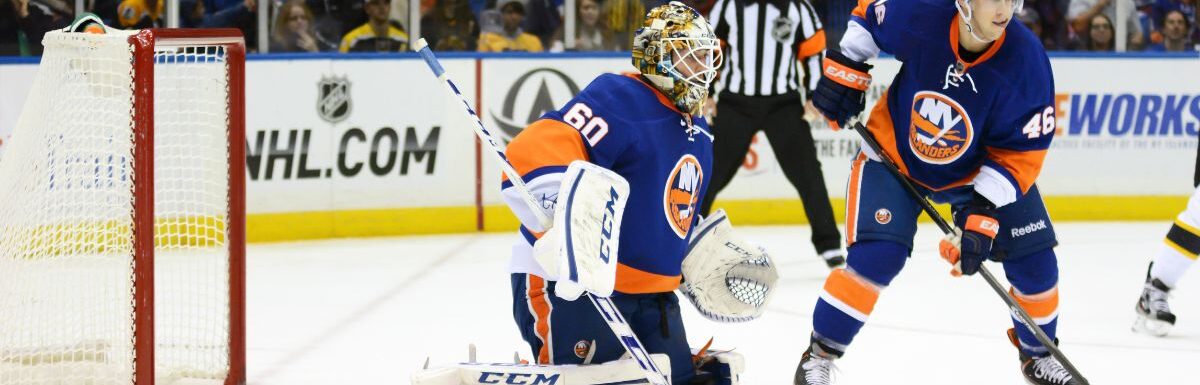 New York Islanders Goalie Kevin Poulin and defenseman Matt Donovan protect the net against the Boston Bruins at Nassau Coliseum.