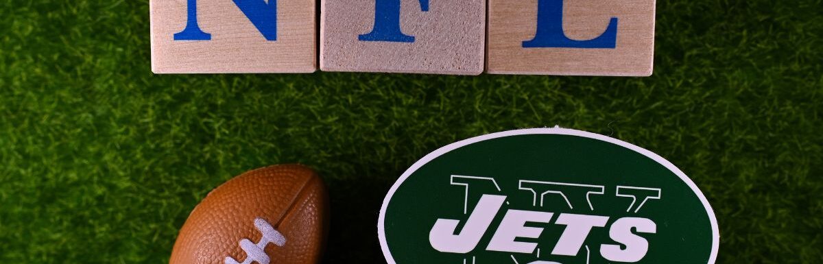 The emblem of the New York Jets football club on the green lawn of the stadium.