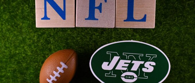 The emblem of the New York Jets football club on the green lawn of the stadium.