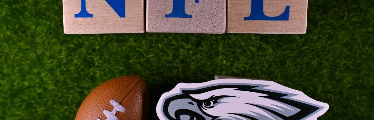 The emblem of the Philadelphia Eagles football club is on the green lawn of the stadium.