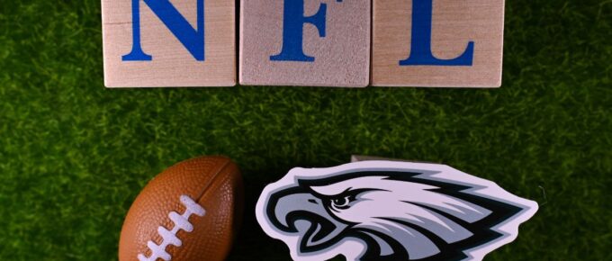 The emblem of the Philadelphia Eagles football club is on the green lawn of the stadium.