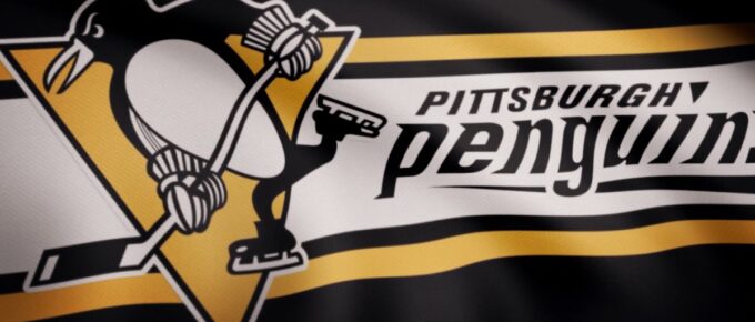 Close-up of waving flag with Pittsburgh Penguins NHL hockey team logo, seamless loop.