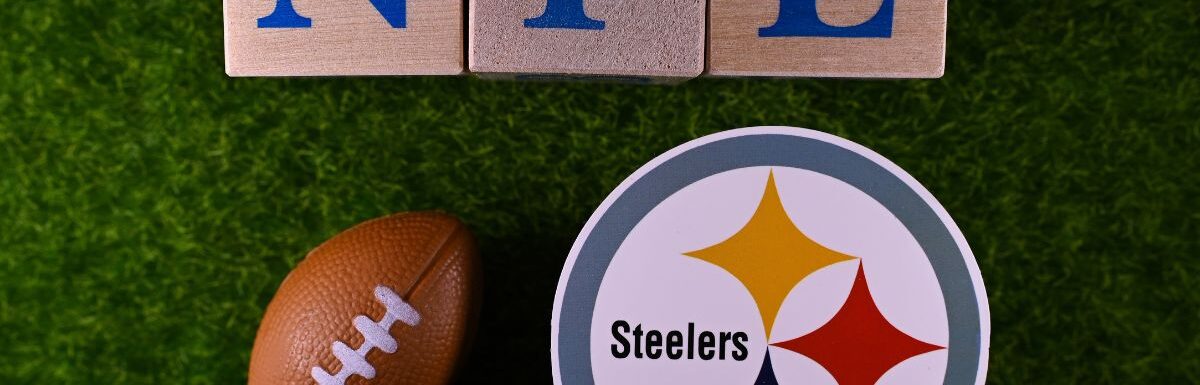 The emblem of the Pittsburgh Steelers football club on the green lawn of the stadium.