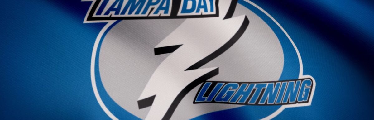 Close-up of waving flag with Tampa Bay Lightning NHL hockey team logo, seamless loop.