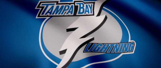 Close-up of waving flag with Tampa Bay Lightning NHL hockey team logo, seamless loop.