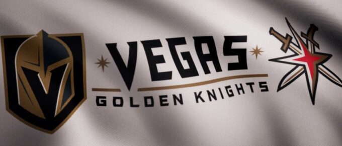 Close-up of waving flag with Vegas Golden Knights NHL hockey team logo, seamless loop.