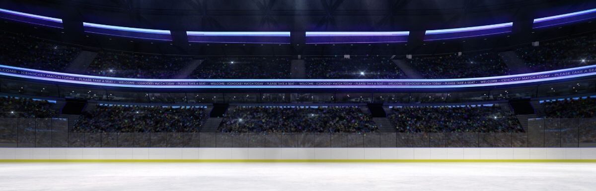 Empty ice rink arena indoor view illuminated by spotlights.