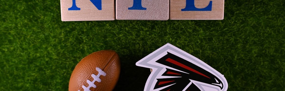 The logo of the Atlanta Falcons football club on the green lawn of the stadium.