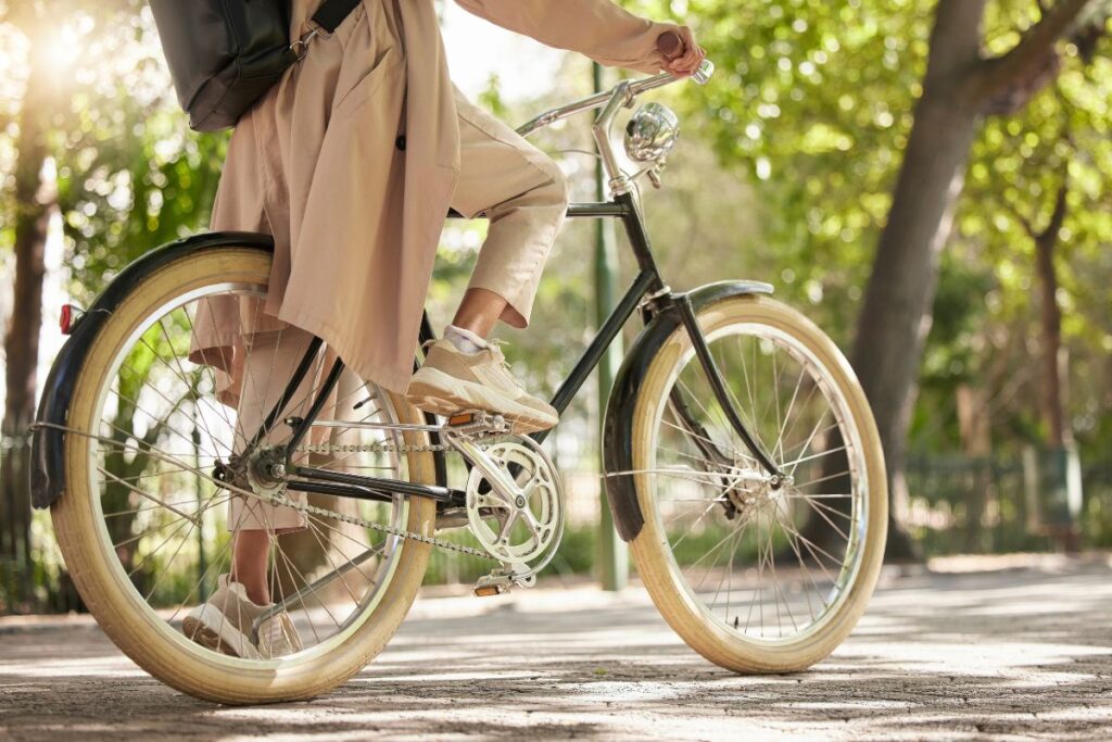 Closeup and feet of casual cyclist travel on a bike.