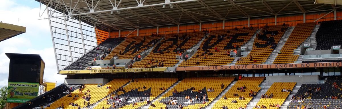 Molineux Stadium with a few people inside during daytime in Wolverhampton, Midlands, England, United Kingdom.